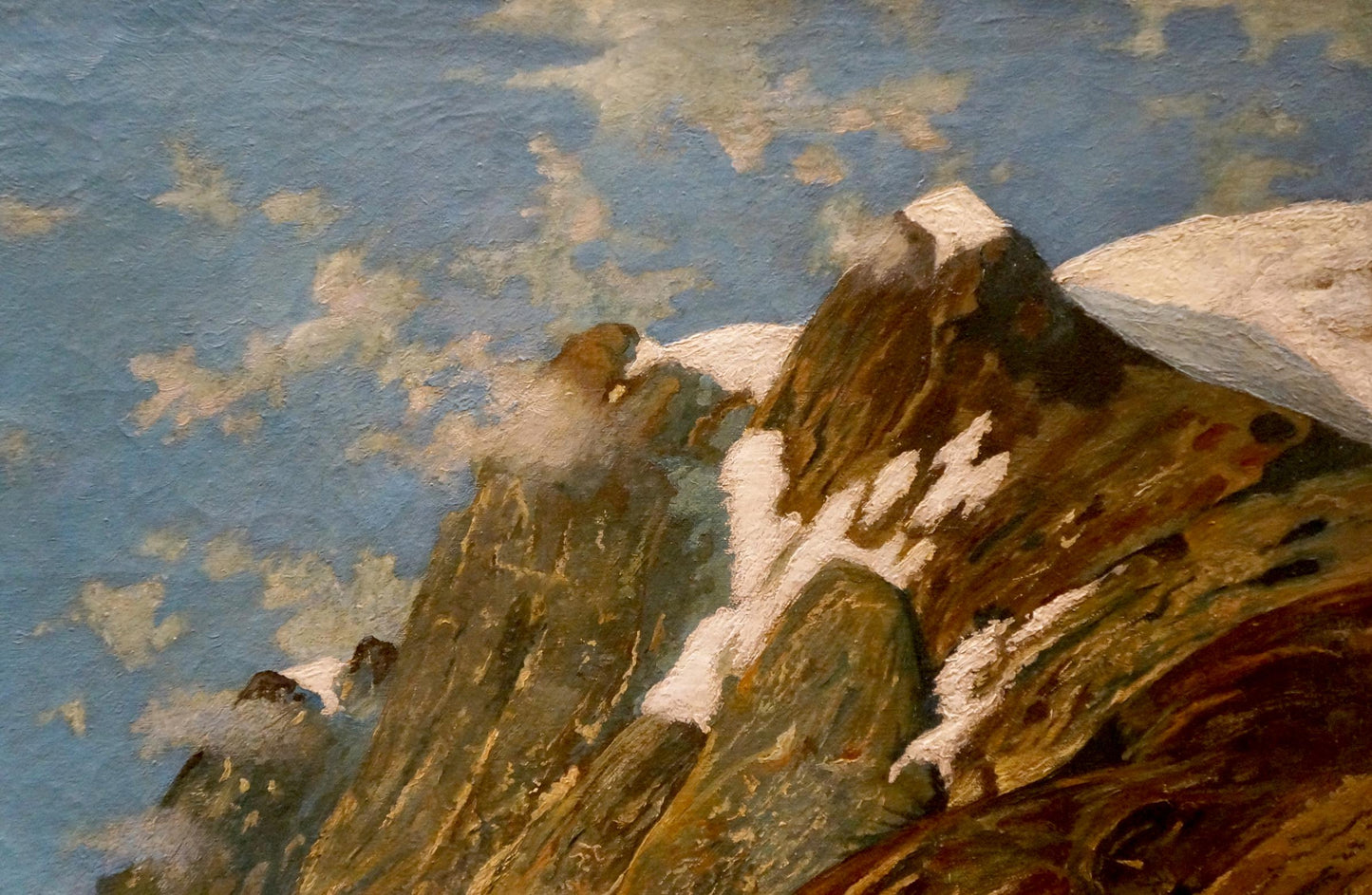 An oil painting by a European artist portrays a river running alongside mountains