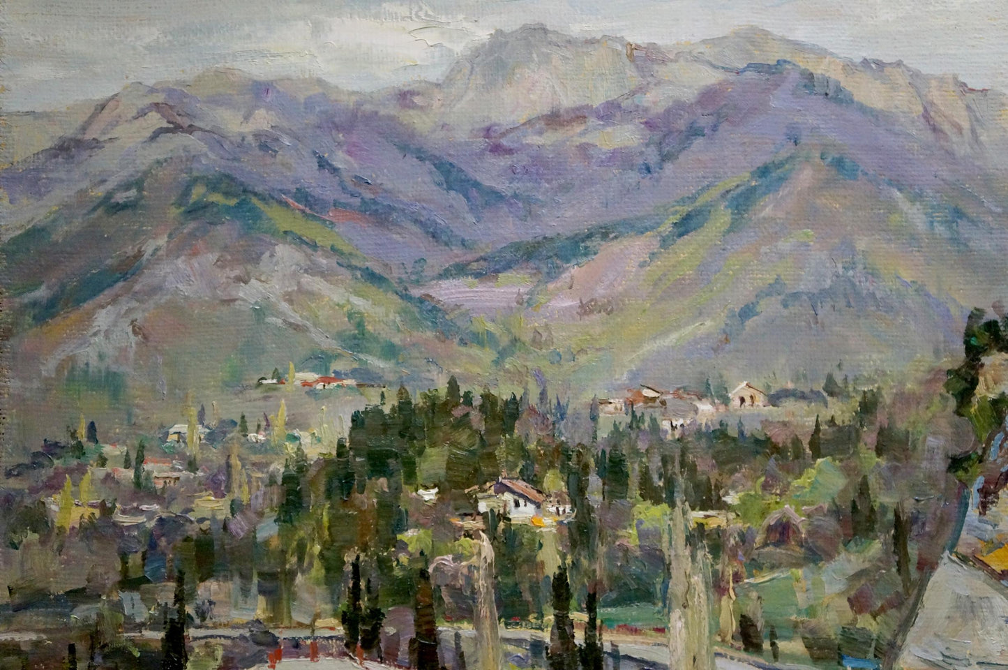 Unknown artist's portrayal of a city nestled among the mountains in oil
