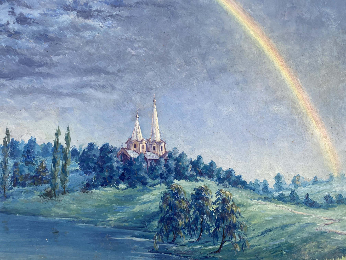A rainbow graces the sky over the church in Alexander Vladimirovich Lesik's oil painting
